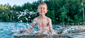 Boy splashing in lake 